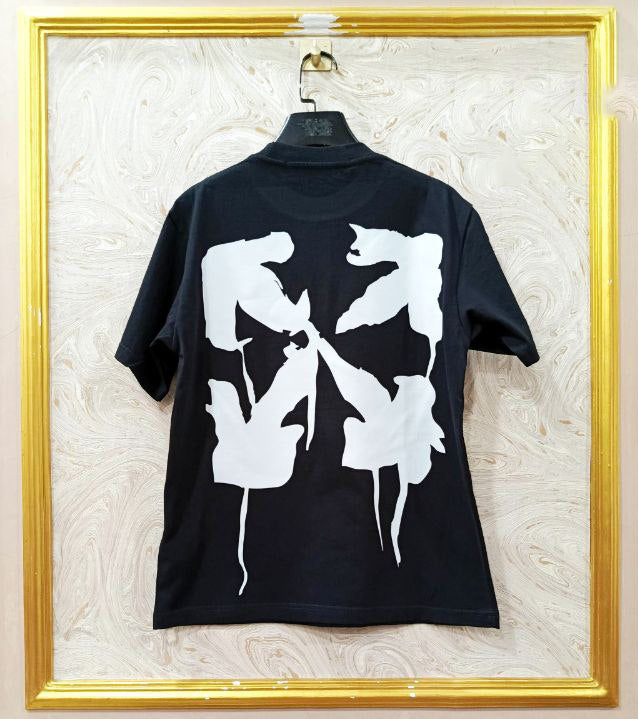 Black t-shirt with white graphic design on a textured wall background