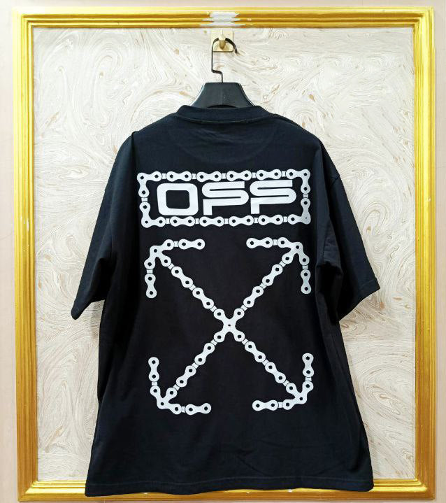 Black t-shirt with "Off-White™" design on a hanger against a decorative wall.