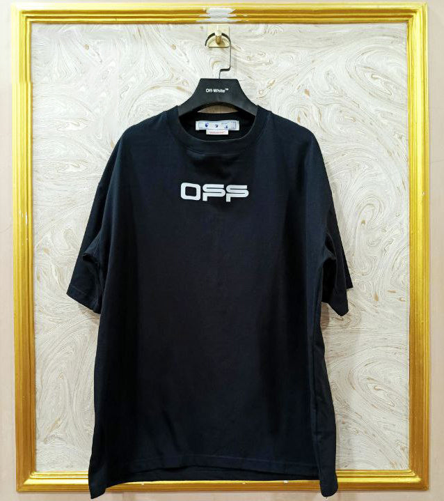 Black t-shirt with "Off-White™" logo on a hanger against a marble wall.