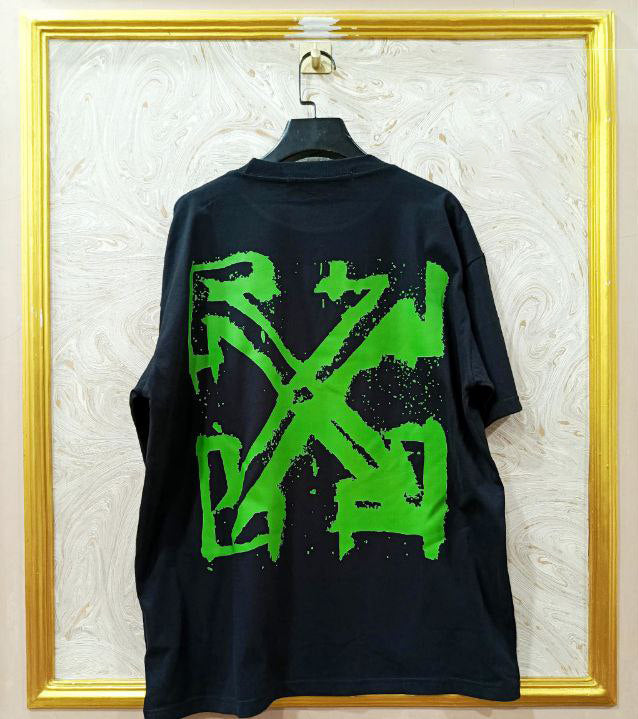 Black t-shirt with "Off-White™" design on a hanger against a decorative wall.