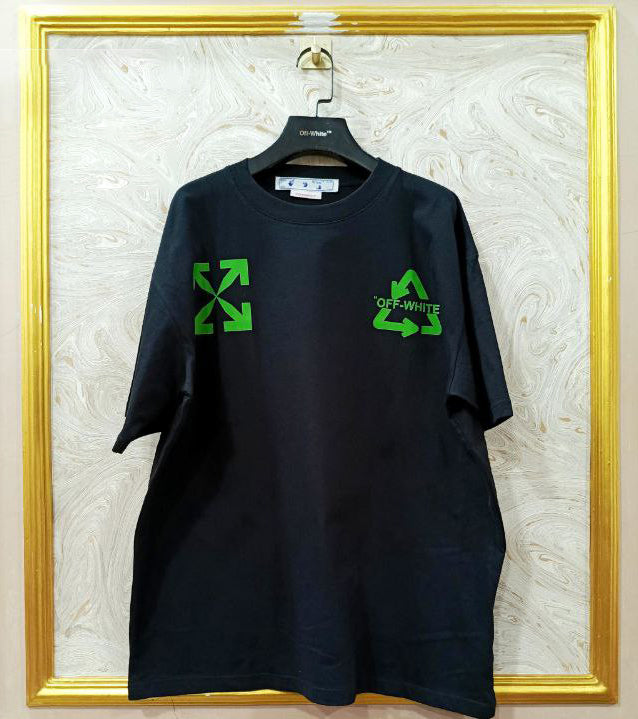 Black t-shirt with "Off-White™" logo on a hanger against a marble wall.