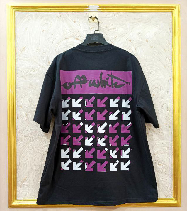 Black t-shirt with "Off-White™" design on a hanger against a decorative wall.