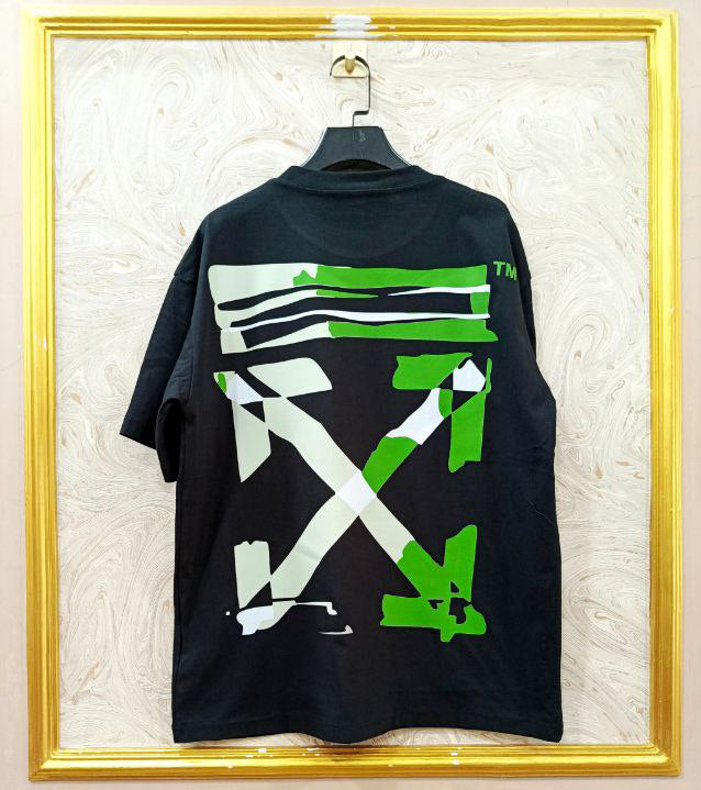 Black t-shirt with "Off-White™" design on a hanger against a decorative wall.