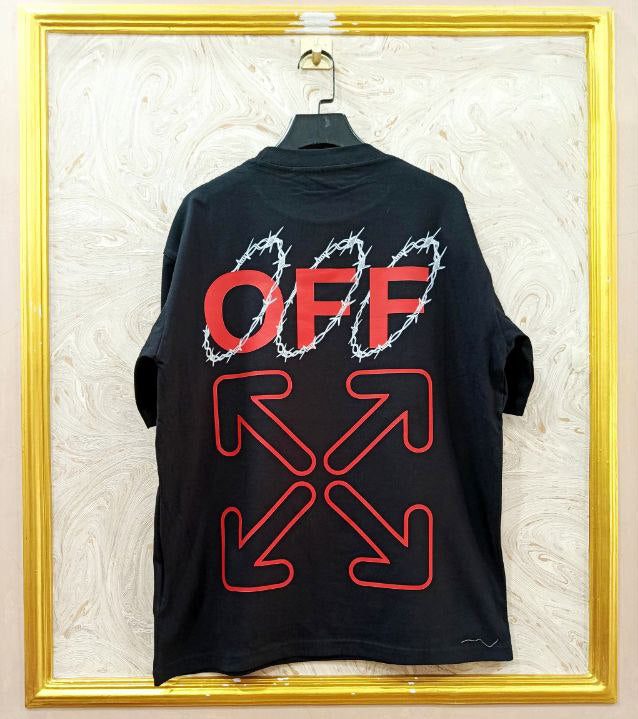 Black t-shirt with "Off-White™" design on a hanger against a decorative wall.