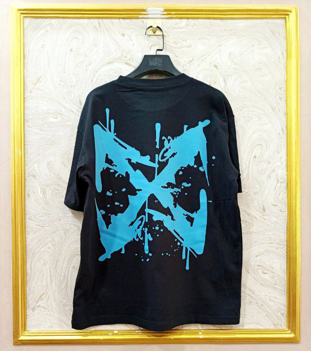 Black t-shirt with "Off-White™" design on a hanger against a decorative wall.