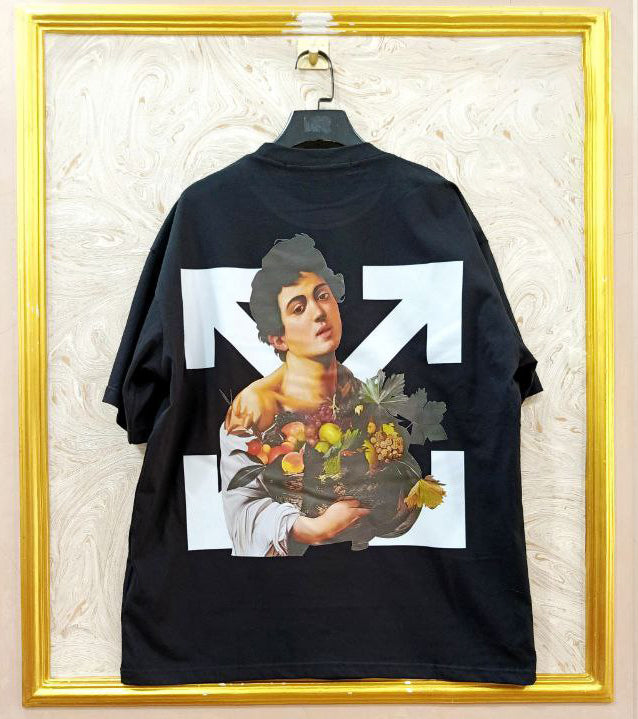 Black t-shirt with "Off-White™" design on a hanger against a decorative wall.
