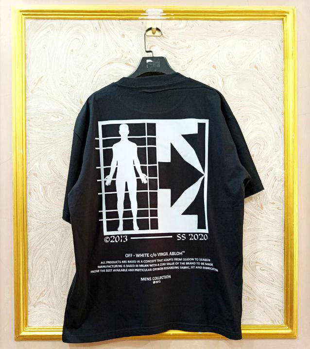 Black t-shirt with "Off-White™" design on a hanger against a decorative wall.