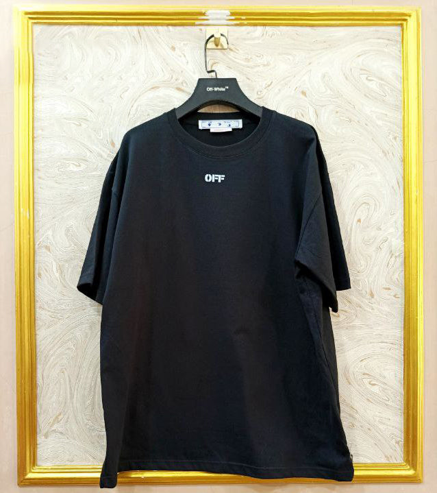 Black t-shirt with "Off-White™" logo on a hanger against a marble wall.