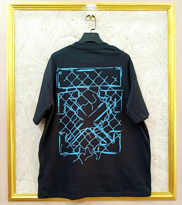 Black t-shirt with "Off-White™" design on a hanger against a decorative wall.