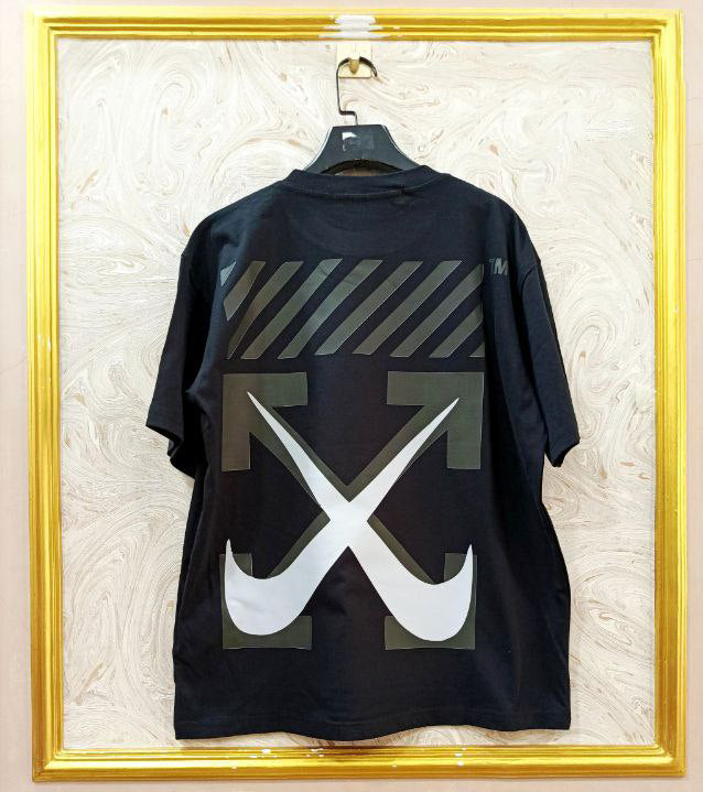 Black t-shirt with "Off-White™" design on a hanger against a decorative wall.