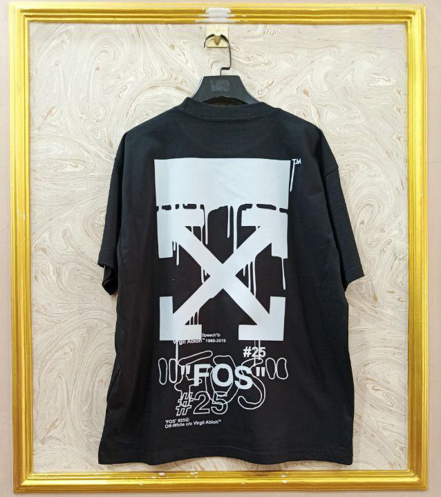 Black t-shirt with "Off-White™" design on a hanger against a decorative wall.
