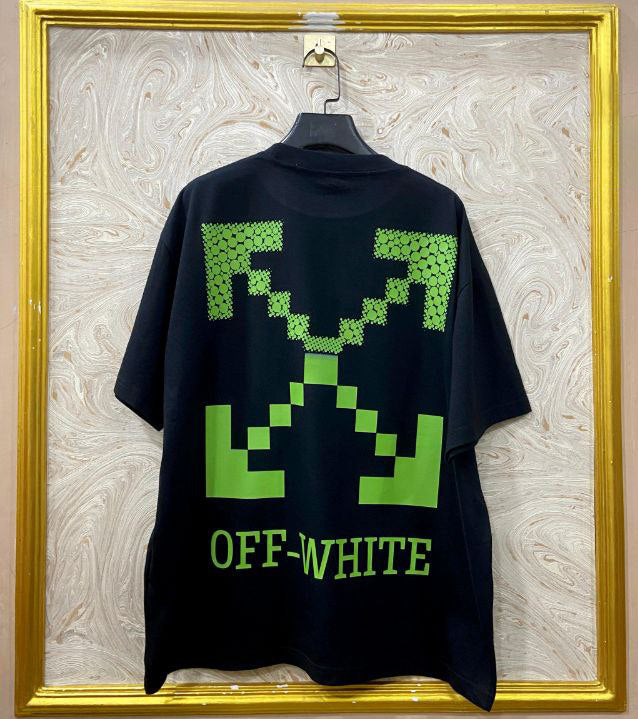 Black t-shirt with "Off-White™" design on a hanger against a decorative wall.