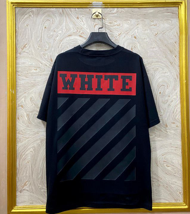 Black t-shirt with "Off-White™" design on a hanger against a decorative wall.