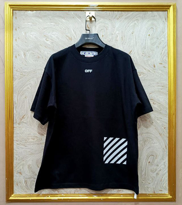 Black t-shirt with "Off-White™" logo on a hanger against a marble wall.