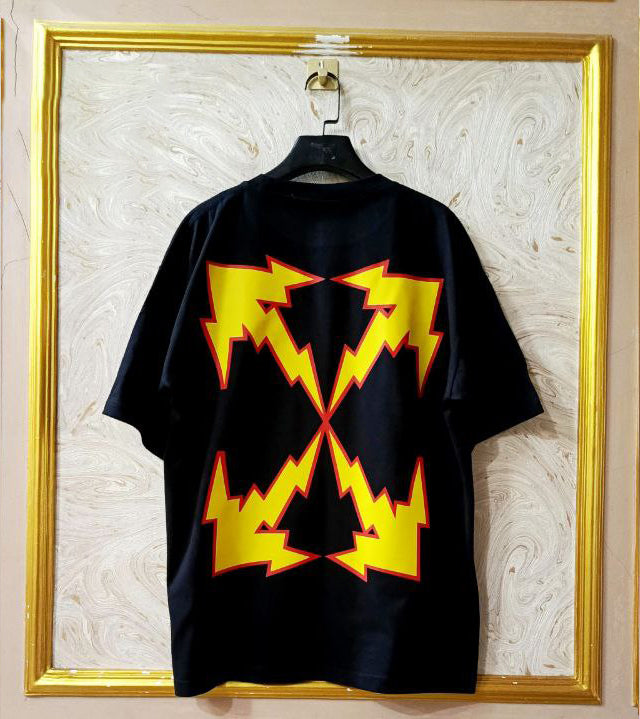 Black t-shirt with "Off-White™" design on a hanger against a decorative wall.