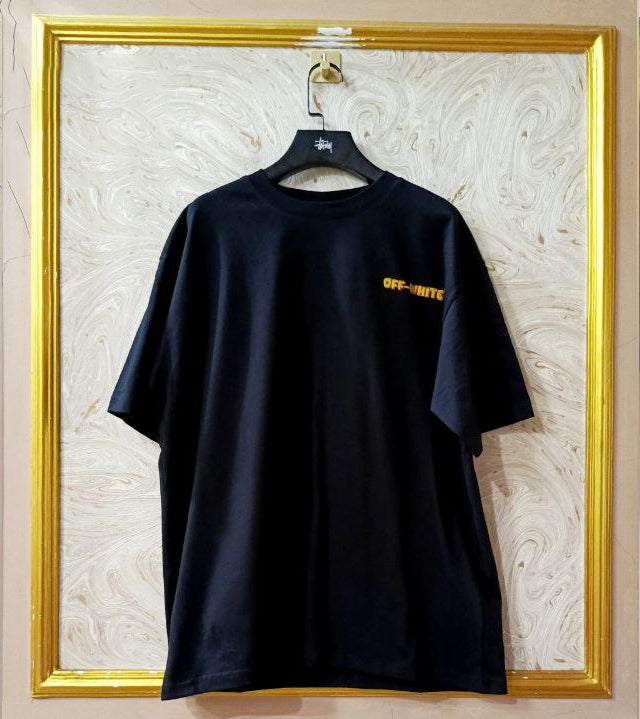 Black t-shirt with "Off-White™" logo on a hanger against a marble wall.