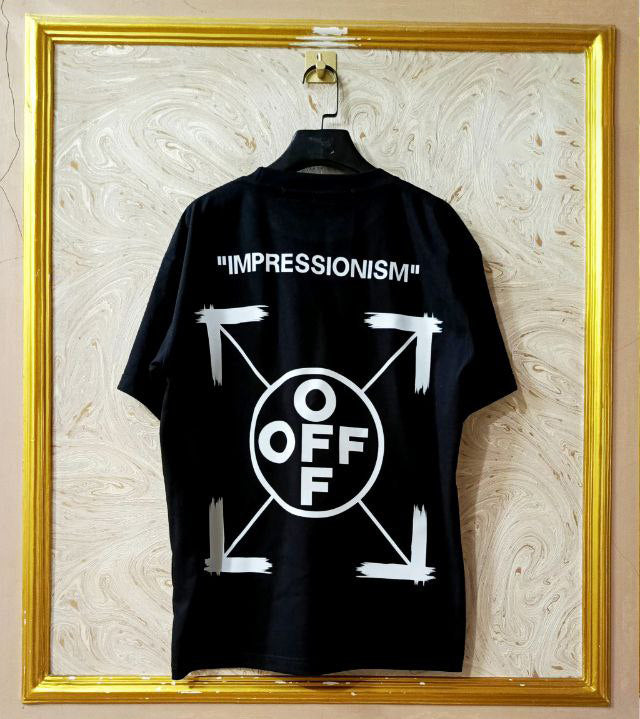 Black t-shirt with "Off-White™" design on a hanger against a decorative wall.