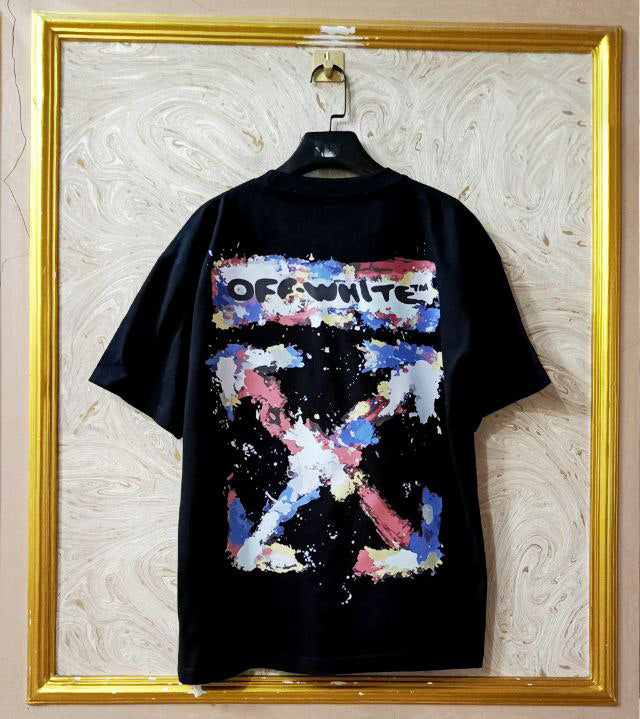 Black t-shirt with "Off-White™" design on a hanger against a decorative wall.