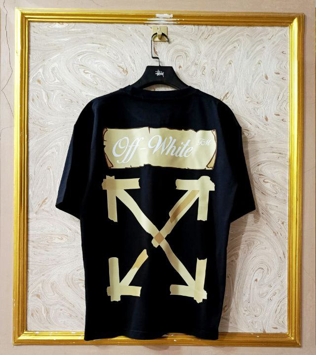 Black t-shirt with "Off-White™" design on a hanger against a decorative wall.