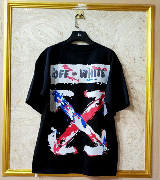 Black t-shirt with "Off-White™" design on a hanger against a decorative wall.