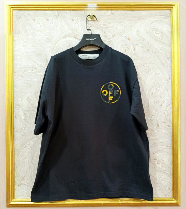 Black t-shirt with "Off-White™" logo on a hanger against a marble wall.