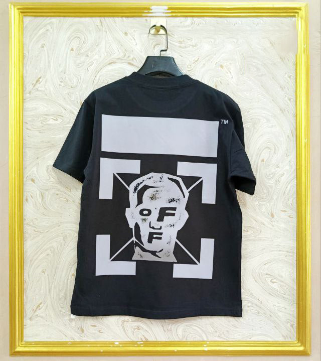 Black t-shirt with "Off-White™" design on a hanger against a decorative wall.