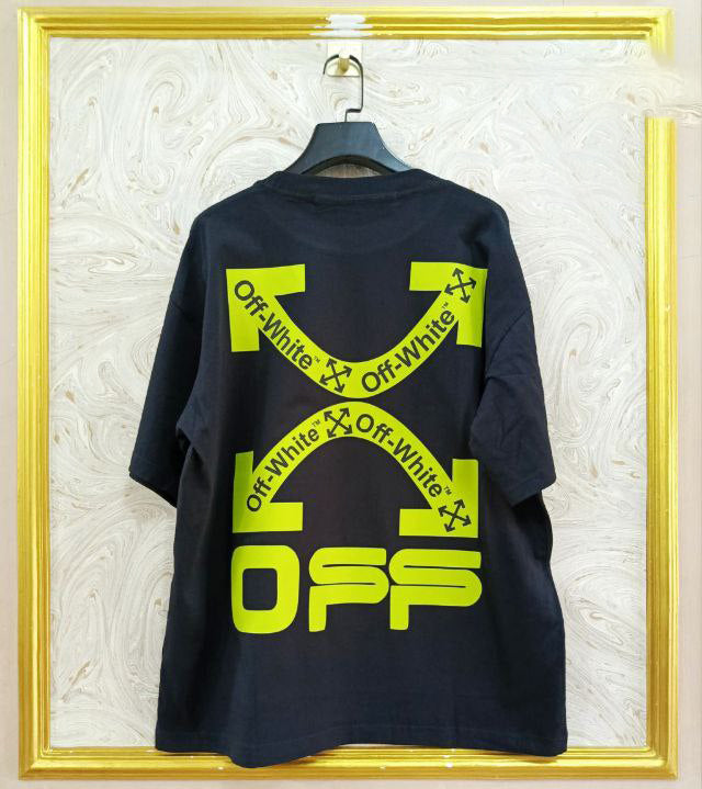 Black t-shirt with "Off-White™" design on a hanger against a decorative wall.