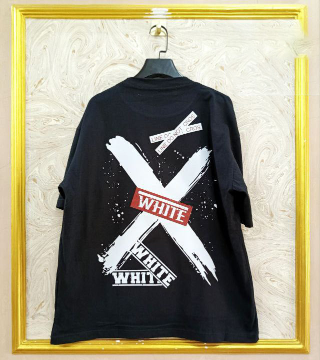 Black t-shirt with "Off-White™" design on a hanger against a decorative wall.