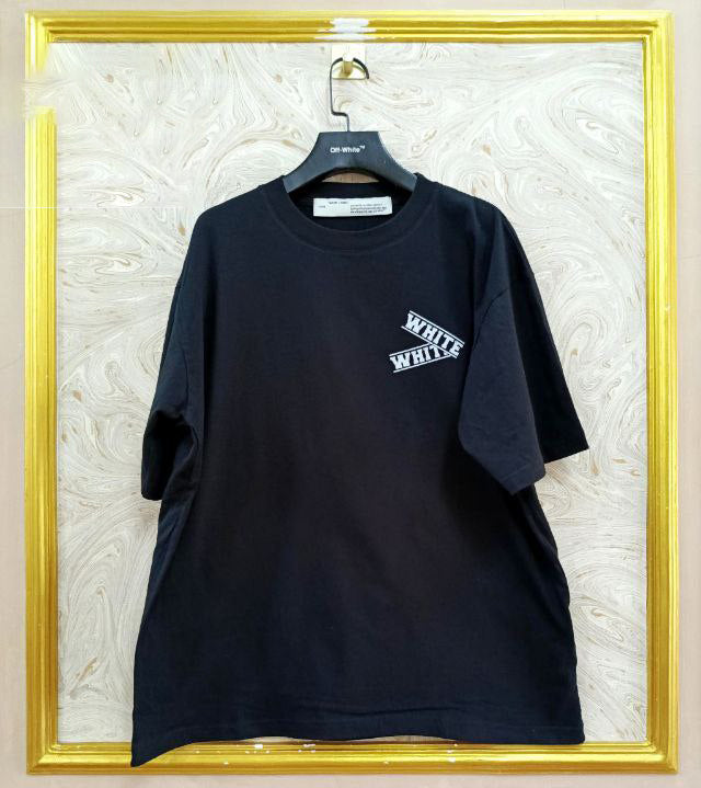 Black t-shirt with "Off-White™" logo on a hanger against a marble wall.