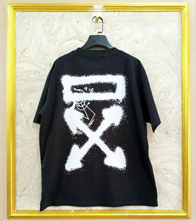 Black t-shirt with "Off-White™" design on a hanger against a decorative wall.
