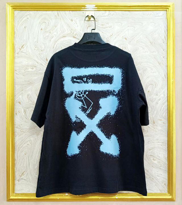 Black t-shirt with "Off-White™" design on a hanger against a decorative wall.