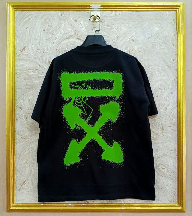 Black t-shirt with "Off-White™" design on a hanger against a decorative wall.