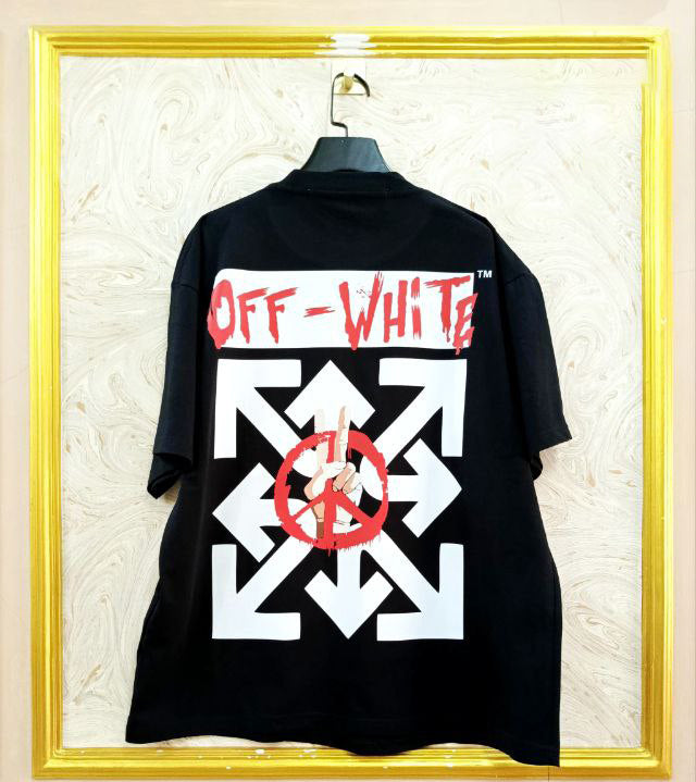 Black t-shirt with "Off-White™" design on a hanger against a decorative wall.