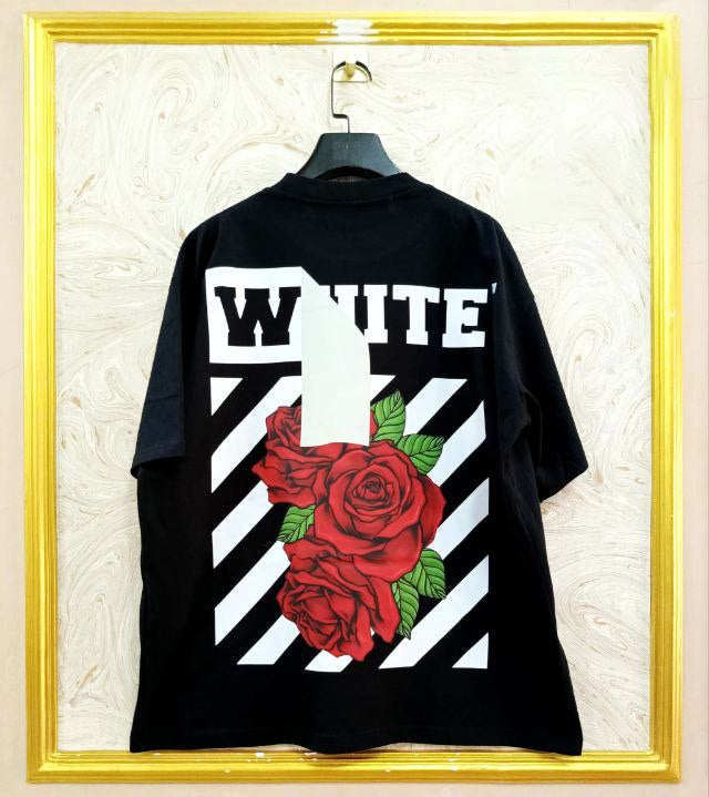 Black t-shirt with "Off-White™" design on a hanger against a decorative wall.