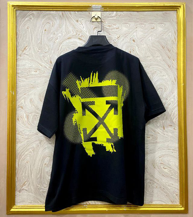 Black t-shirt with "Off-White™" design on a hanger against a decorative wall.