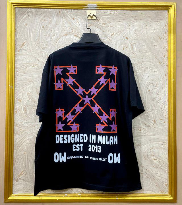 Black t-shirt with "Off-White™" design on a hanger against a decorative wall.