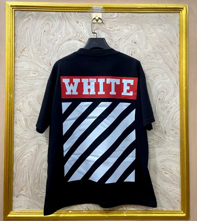 Black t-shirt with "Off-White™" design on a hanger against a decorative wall.