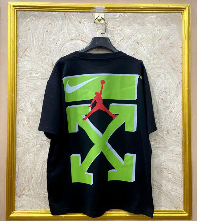 Black t-shirt with "Off-White™" design on a hanger against a decorative wall.