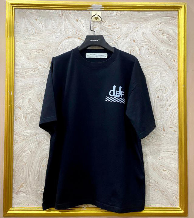 Black t-shirt with "Off-White™" logo on a hanger against a marble wall.