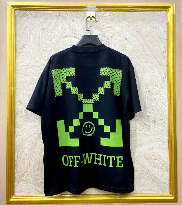 Black t-shirt with "Off-White™" design on a hanger against a decorative wall.