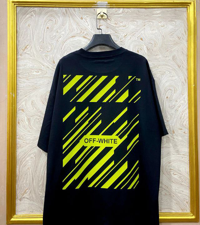 Black t-shirt with "Off-White™" design on a hanger against a decorative wall.