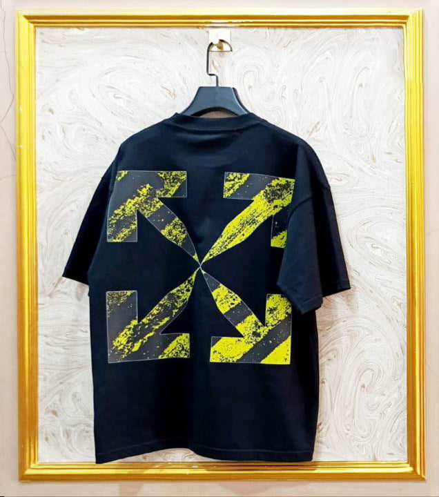 Back view of black oversized t-shirt inspired by Off-White with white diagonal stripes, “OFF” text, and yellow industrial belt graphic crossing the print.