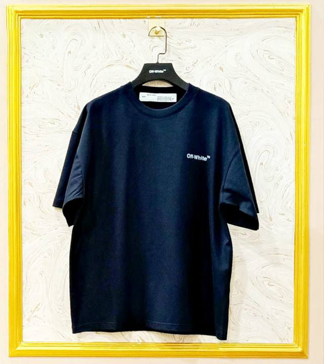 Black t-shirt with "Off-White™" logo on a hanger against a marble wall.