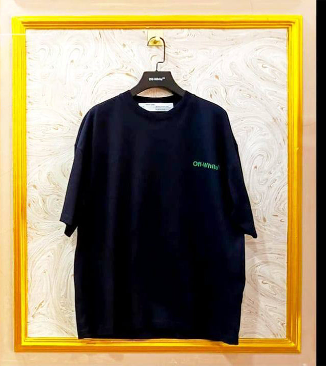 Black t-shirt with "Off-White™" logo on a hanger against a marble wall.