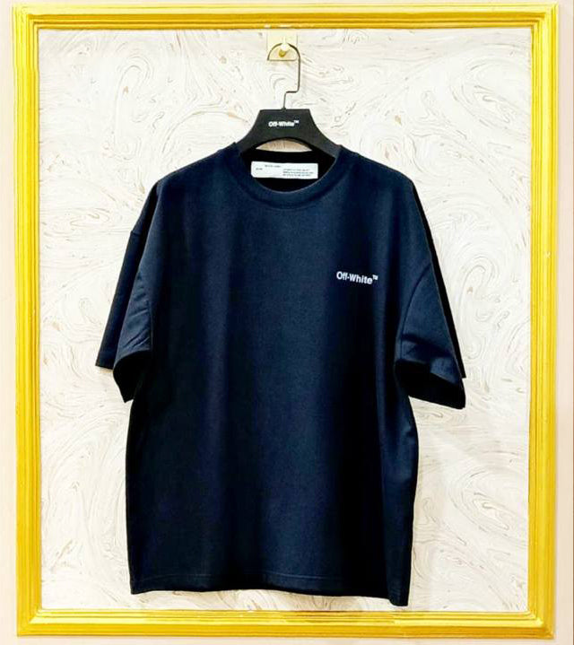Black t-shirt with "Off-White™" logo on a hanger against a marble wall.