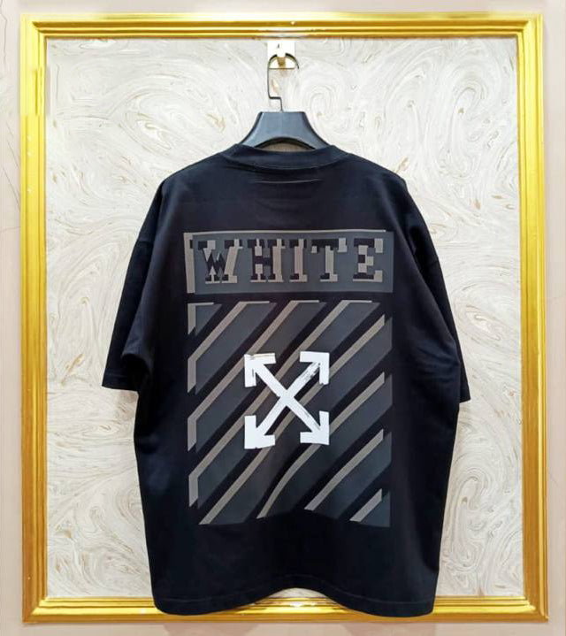 Black t-shirt with "Off-White™" design on a hanger against a decorative wall.