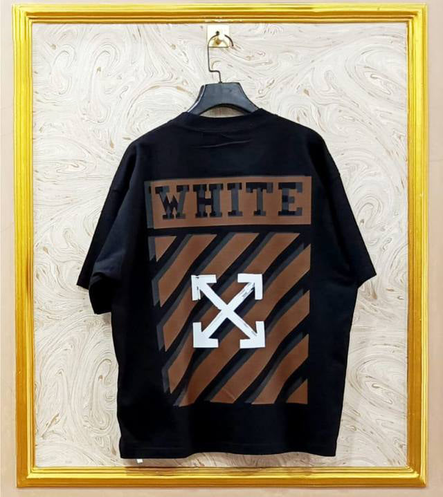 Black t-shirt with "Off-White™" design on a hanger against a decorative wall.