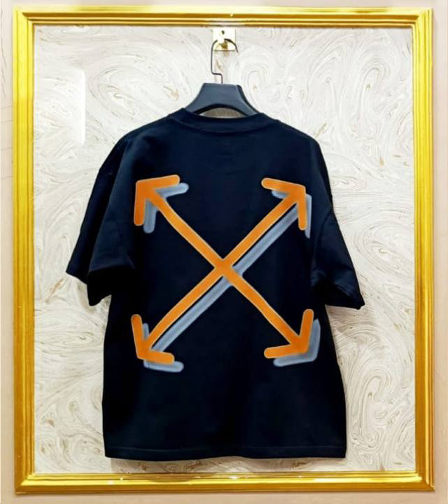 Black t-shirt with "Off-White™" design on a hanger against a decorative wall.