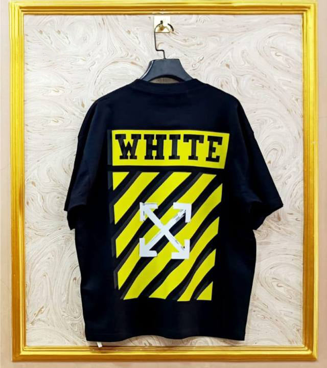 Black t-shirt with "Off-White™" design on a hanger against a decorative wall.