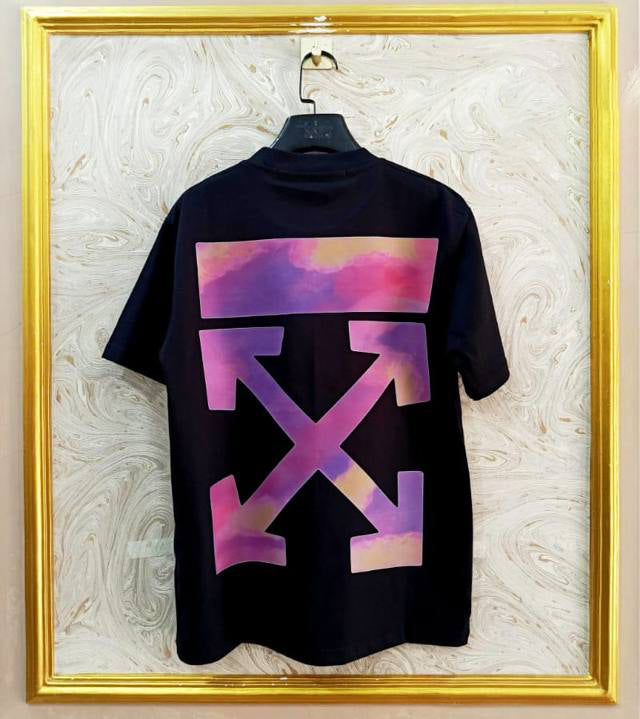 Black t-shirt with "Off-White™" design on a hanger against a decorative wall.